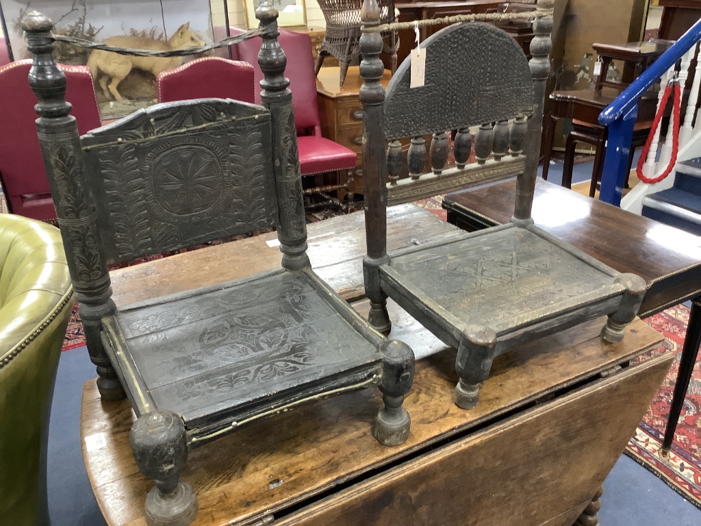 Two African carved hardwood seats, width 49cm, depth 39cm, height 64cm